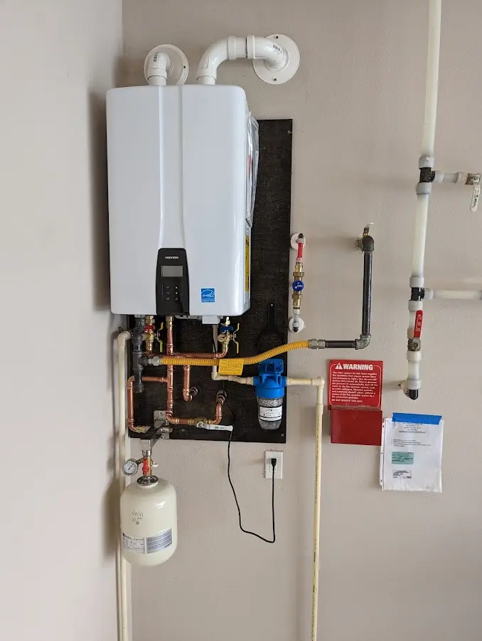 Professional plumber installing copper piping in a South Huntingdon home